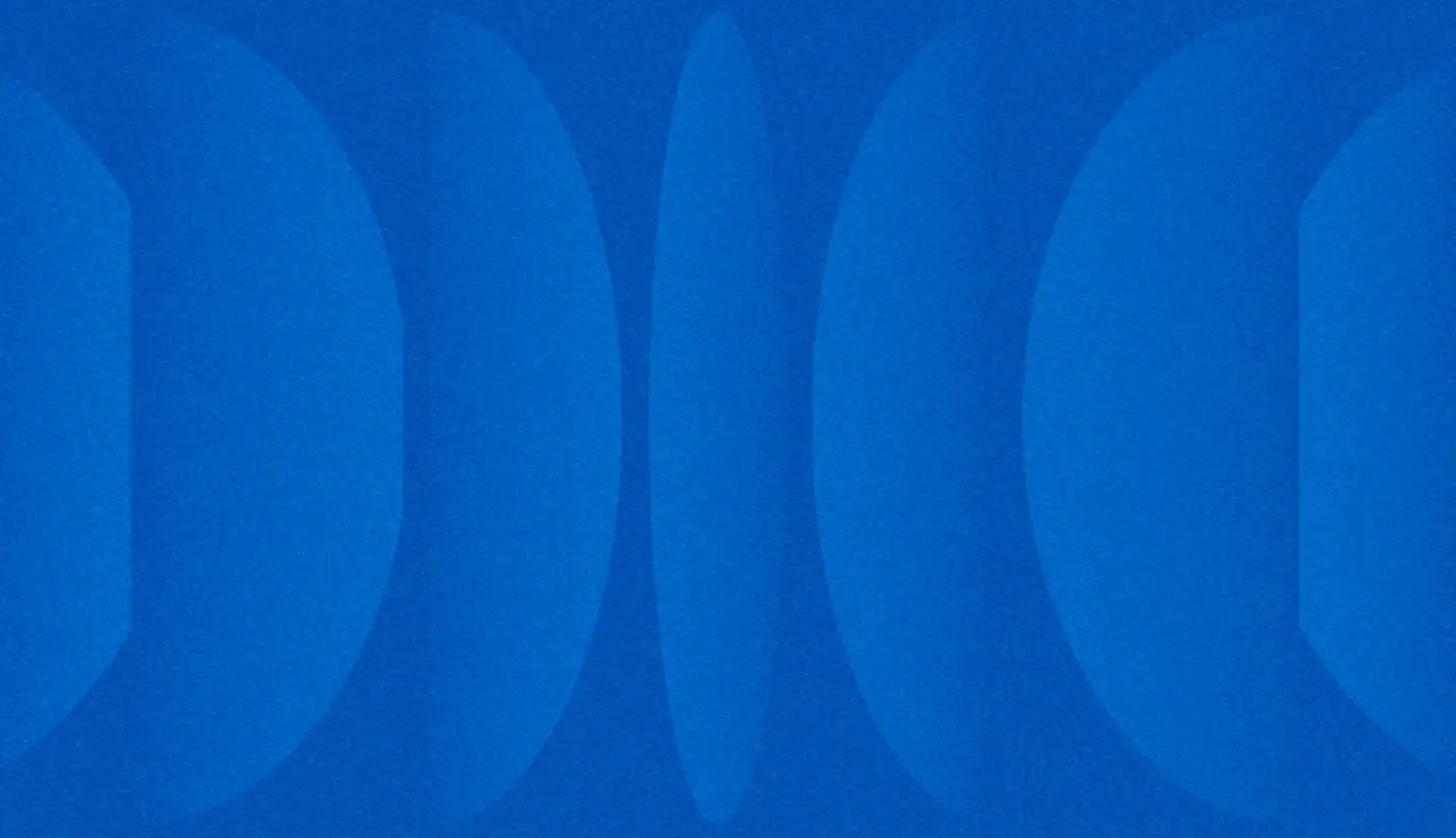 Repeating tonal blue curved and oval shapes forming a subtle abstract pattern.